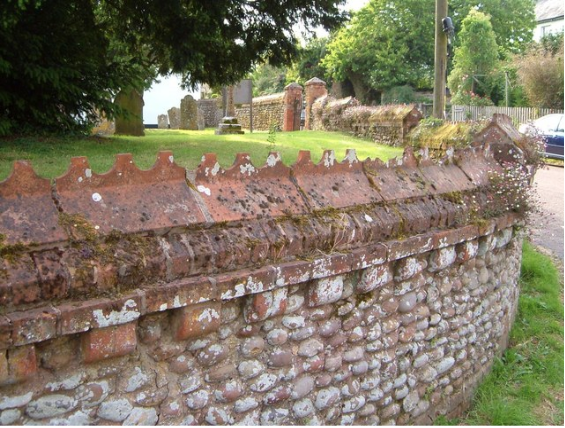 an image of decorative wall coping stones atop the outside walls of a church